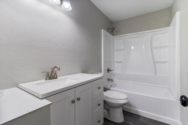 1945 Debra Dr, West Plains, MO 65775 - full bath with shower / bathtub combination, vanity, toilet, wood finished floors, and a textured wall