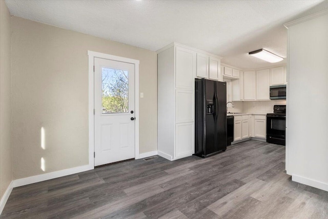 1945 Debra Dr, West Plains, MO 65775 - kitchen with dark wood-type flooring, white cabinetry, black appliances, a sink, and decorative backsplash