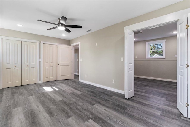 1945 Debra Dr, West Plains, MO 65775 - unfurnished bedroom featuring ceiling fan, visible vents, wood finished floors, multiple closets, and baseboards