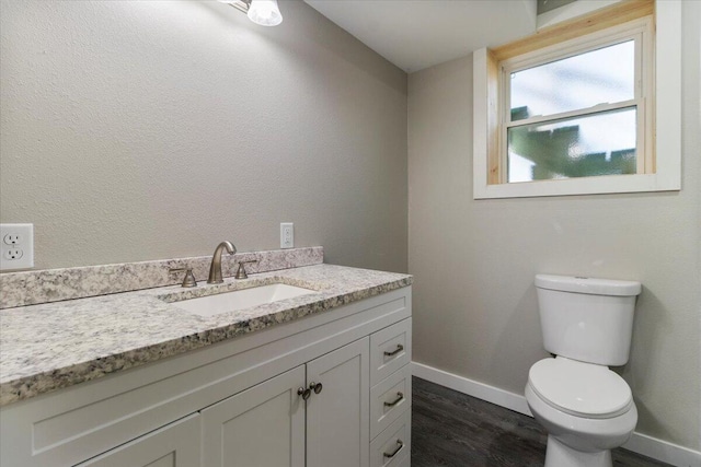1945 Debra Dr, West Plains, MO 65775 - bathroom with toilet, wood finished floors, vanity, and baseboards