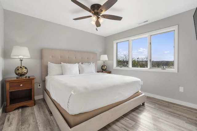 611 Rock Ln Unit 402, Branson, MO 65616 - bedroom featuring baseboards, ceiling fan, visible vents, and wood finished floors