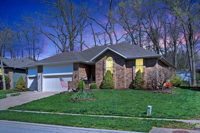 ranch-style house with a garage, driveway, brick siding, a shingled roof, and a yard