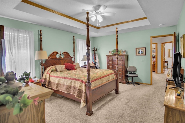 bedroom featuring baseboards, carpet flooring, a raised ceiling, and ornamental molding