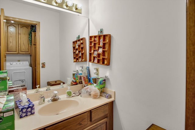 bathroom with vanity and washer / dryer