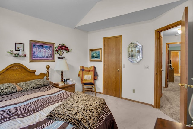 bedroom with baseboards, lofted ceiling, and light carpet