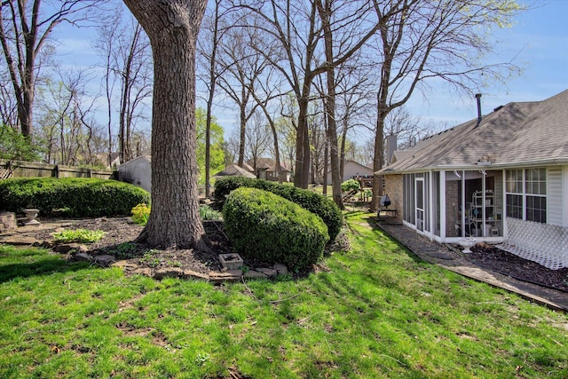 view of yard with fence and a sunroom