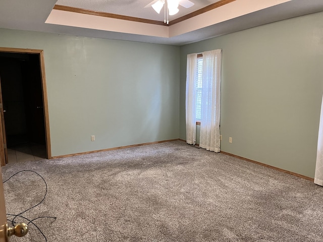 3899 W Woodland St, Springfield, MO 65807 - carpeted empty room with a tray ceiling, baseboards, and a ceiling fan