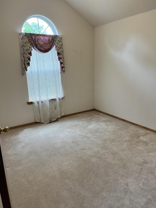 3899 W Woodland St, Springfield, MO 65807 - spare room featuring vaulted ceiling, carpet floors, and baseboards