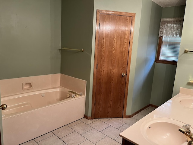 3899 W Woodland St, Springfield, MO 65807 - bathroom featuring a garden tub, double vanity, baseboards, and tile patterned floors