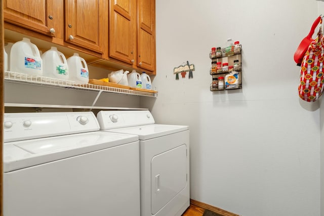 laundry area featuring cabinet space, independent washer and dryer, and baseboards