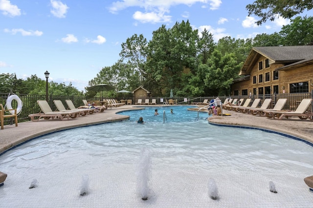 pool featuring a patio area and fence