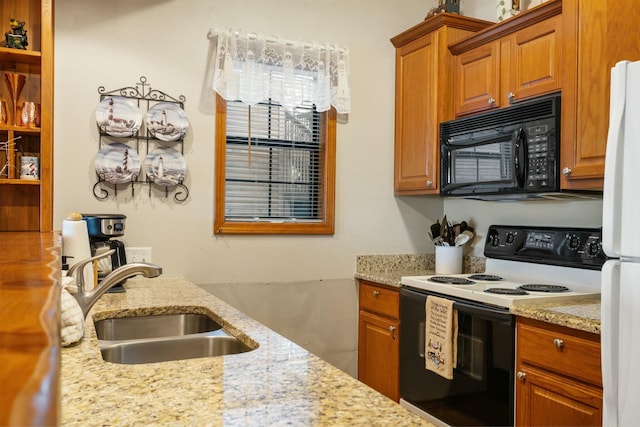 kitchen with a sink, black microwave, electric range, and brown cabinets