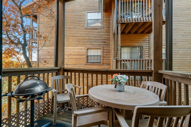 wooden deck with area for grilling and outdoor dining space
