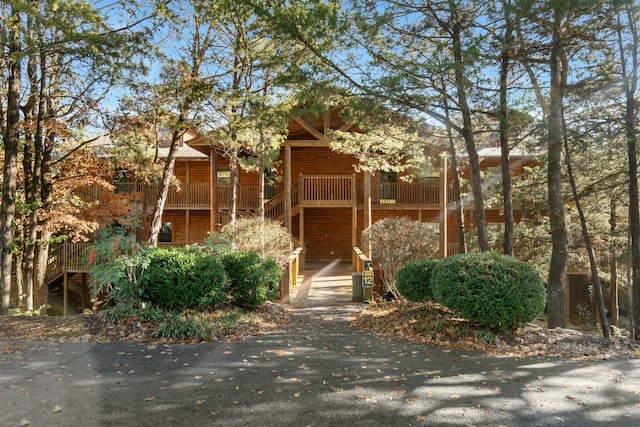 view of front of home with faux log siding and stairs