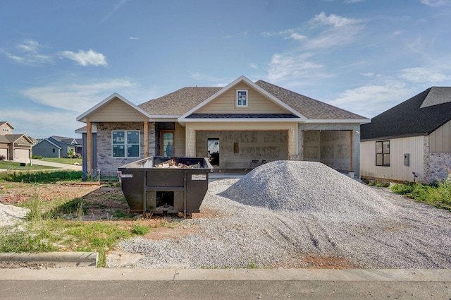 LOT69 W Marty St, Springfield, MO 65810 - view of front facade with gravel driveway, an attached garage, and a shingled roof