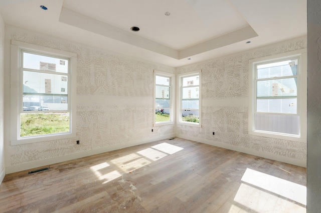 LOT69 W Marty St, Springfield, MO 65810 - empty room featuring wood finished floors, a tray ceiling, and wallpapered walls