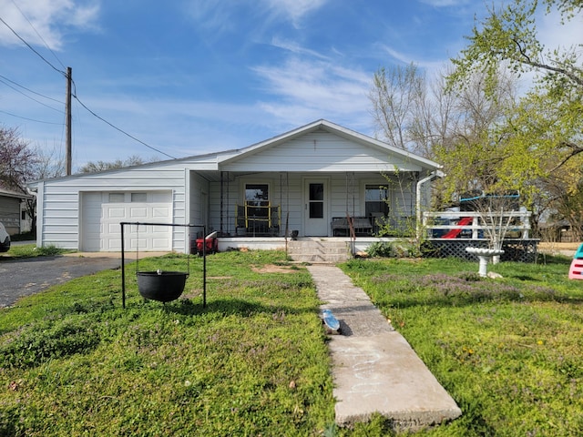 350 Kentling Ave, Highlandville, MO 65669 - view of front of home with an attached garage, covered porch, driveway, and a front lawn