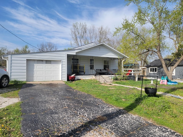 350 Kentling Ave, Highlandville, MO 65669 - view of front of home featuring a porch, an attached garage, aphalt driveway, and a front yard