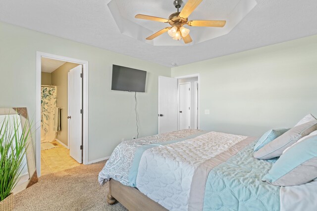 715 Woodlawn St, Marshfield, MO 65706 - bedroom with baseboards, a textured ceiling, a tray ceiling, ceiling fan, and light colored carpet