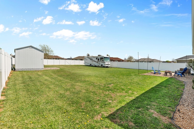 715 Woodlawn St, Marshfield, MO 65706 - view of yard with an outbuilding, a storage shed, a fenced backyard, a patio area, and a fire pit