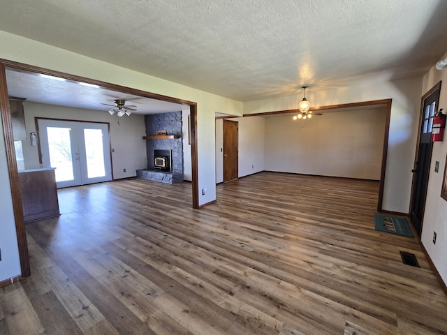 21282 County Road 295, Hermitage, MO 65668 - unfurnished living room featuring french doors, a textured ceiling, visible vents, wood finished floors, and ceiling fan