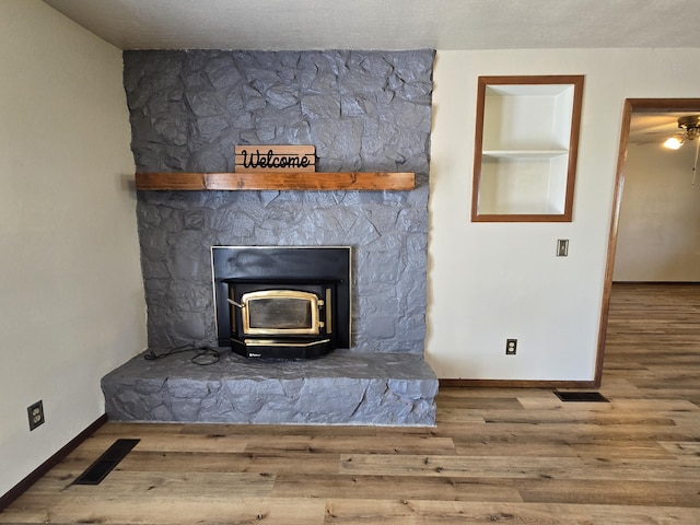 21282 County Road 295, Hermitage, MO 65668 - interior details with baseboards, wood finished floors, visible vents, and a wood stove