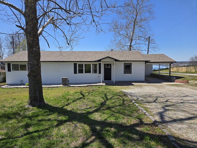 21282 County Road 295, Hermitage, MO 65668 - ranch-style house featuring central air condition unit, driveway, an attached carport, and a front yard