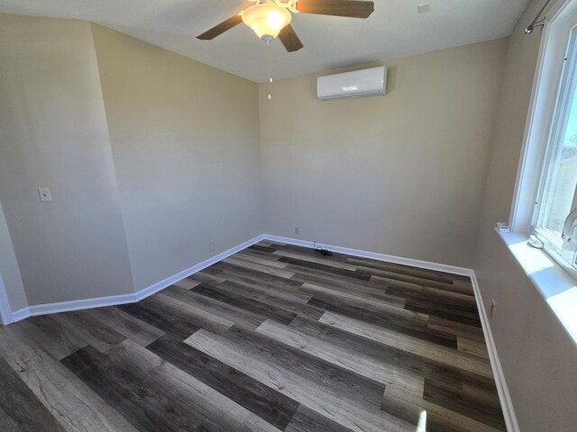 21282 County Road 295, Hermitage, MO 65668 - unfurnished room featuring a wall mounted air conditioner, baseboards, a ceiling fan, and wood finished floors