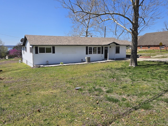 21282 County Road 295, Hermitage, MO 65668 - view of front of home featuring a shingled roof, a front lawn, and central AC unit