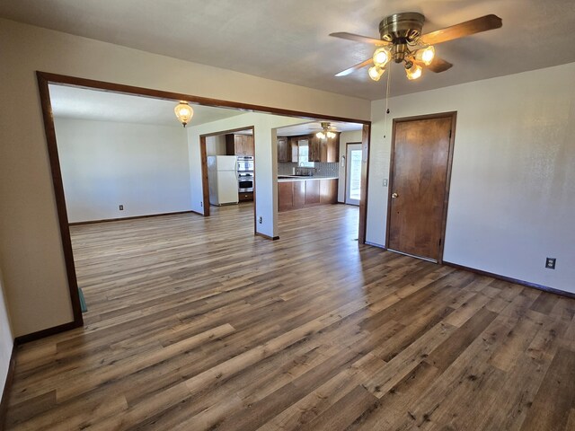 21282 County Road 295, Hermitage, MO 65668 - interior space with baseboards, dark wood-style floors, and ceiling fan