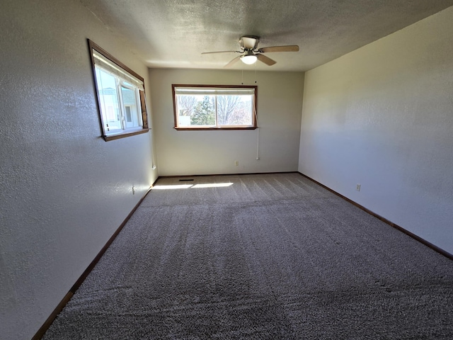 21282 County Road 295, Hermitage, MO 65668 - carpeted empty room with a ceiling fan, baseboards, a textured wall, and a textured ceiling