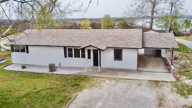 21282 County Road 295, Hermitage, MO 65668 - ranch-style home with an attached carport, central air condition unit, driveway, a shingled roof, and a front yard