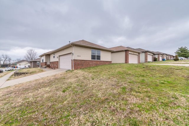 3335 W Countryside Dr, Springfield, MO 65807 - view of front of home featuring a garage, brick siding, a front lawn, and concrete driveway