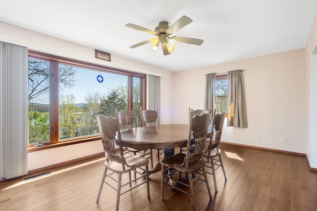 205 Forest Ln, Kimberling City, MO 65686 - dining room with baseboards, wood finished floors, and ceiling fan