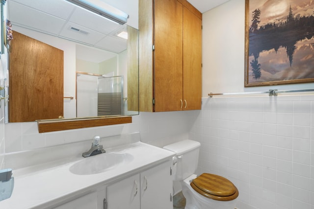 205 Forest Ln, Kimberling City, MO 65686 - full bathroom with a stall shower, toilet, tile walls, vanity, and wainscoting