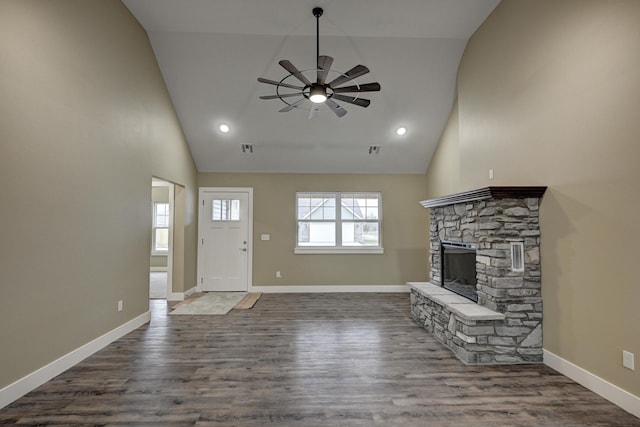 unfurnished living room with dark wood-type flooring, ceiling fan, baseboards, and a healthy amount of sunlight
