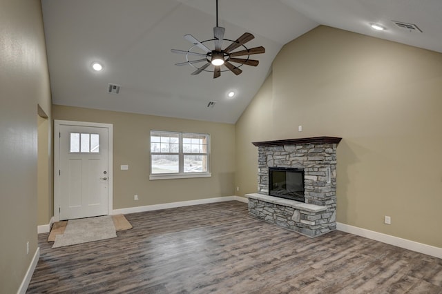 unfurnished living room featuring visible vents, ceiling fan, wood finished floors, and a fireplace