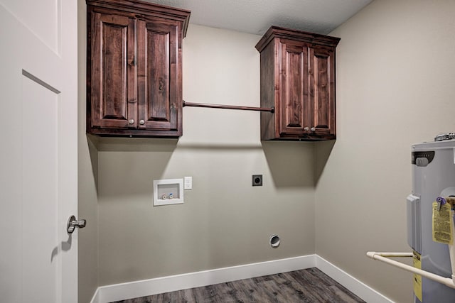 laundry room featuring electric water heater, electric dryer hookup, baseboards, hookup for a washing machine, and cabinet space