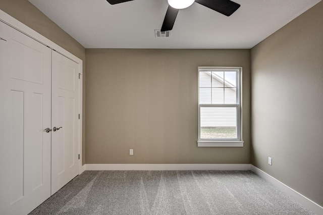 unfurnished bedroom with visible vents, baseboards, a ceiling fan, and carpet