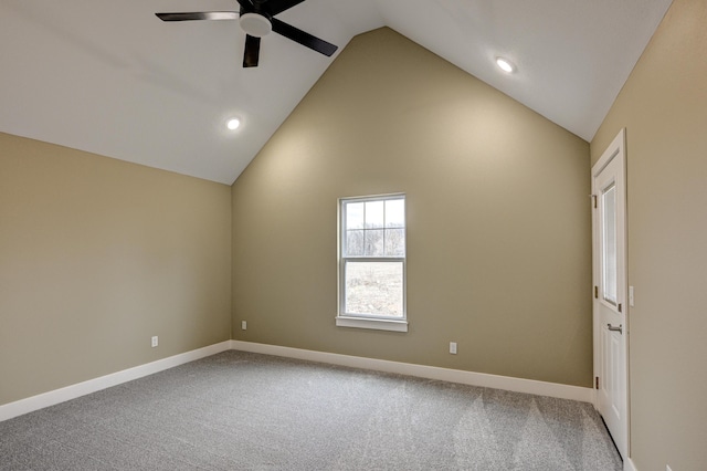 empty room featuring baseboards, a ceiling fan, high vaulted ceiling, and carpet