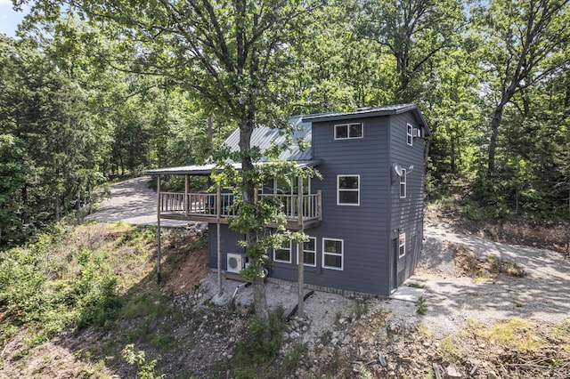 27857 Farm Rd Unit 1250, Golden, MO 65658 - back of house with metal roof, a wooden deck, and a view of trees