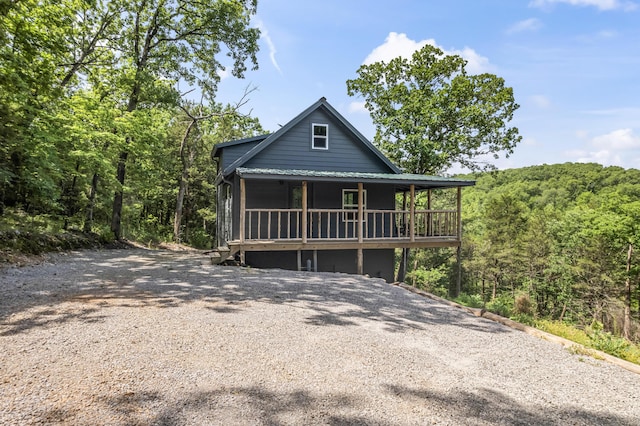 27857 Farm Rd Unit 1250, Golden, MO 65658 - view of front of home with a porch, driveway, metal roof, and a forest view