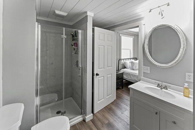 27857 Farm Rd Unit 1250, Golden, MO 65658 - bathroom featuring toilet, a stall shower, wood finished floors, vanity, and ensuite bathroom