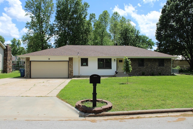 2558 W Village Ln, Springfield, MO 65807 - ranch-style house featuring stone siding, a garage, driveway, and a front yard