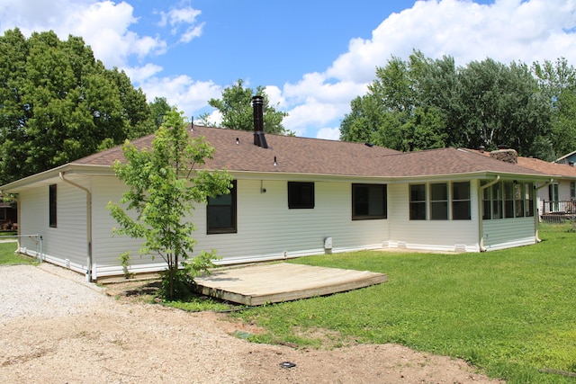 2558 W Village Ln, Springfield, MO 65807 - rear view of house featuring a deck, a shingled roof, and a lawn