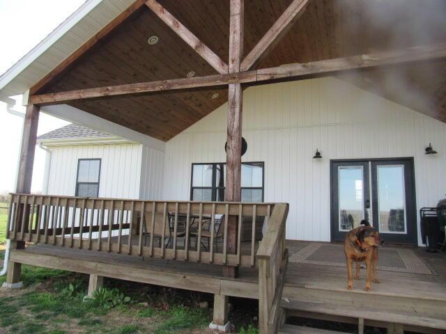 rear view of house featuring a deck and outdoor dining space