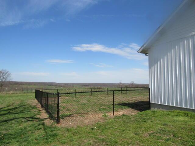 view of yard featuring a rural view and fence