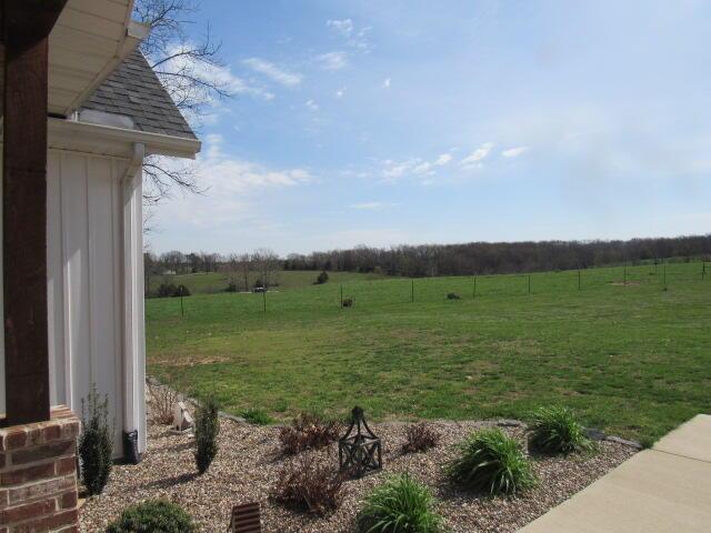 view of yard with a rural view