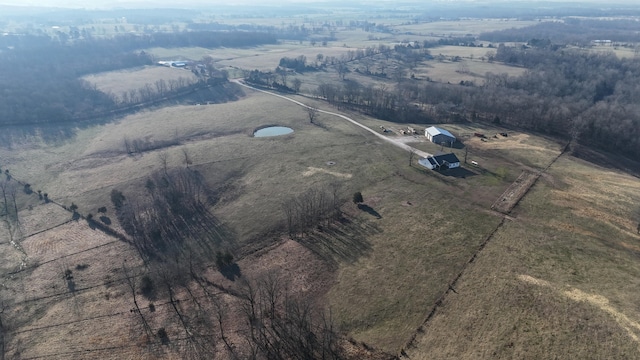 birds eye view of property with a rural view