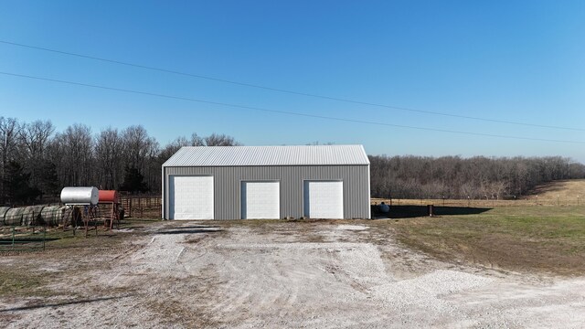 detached garage featuring fence